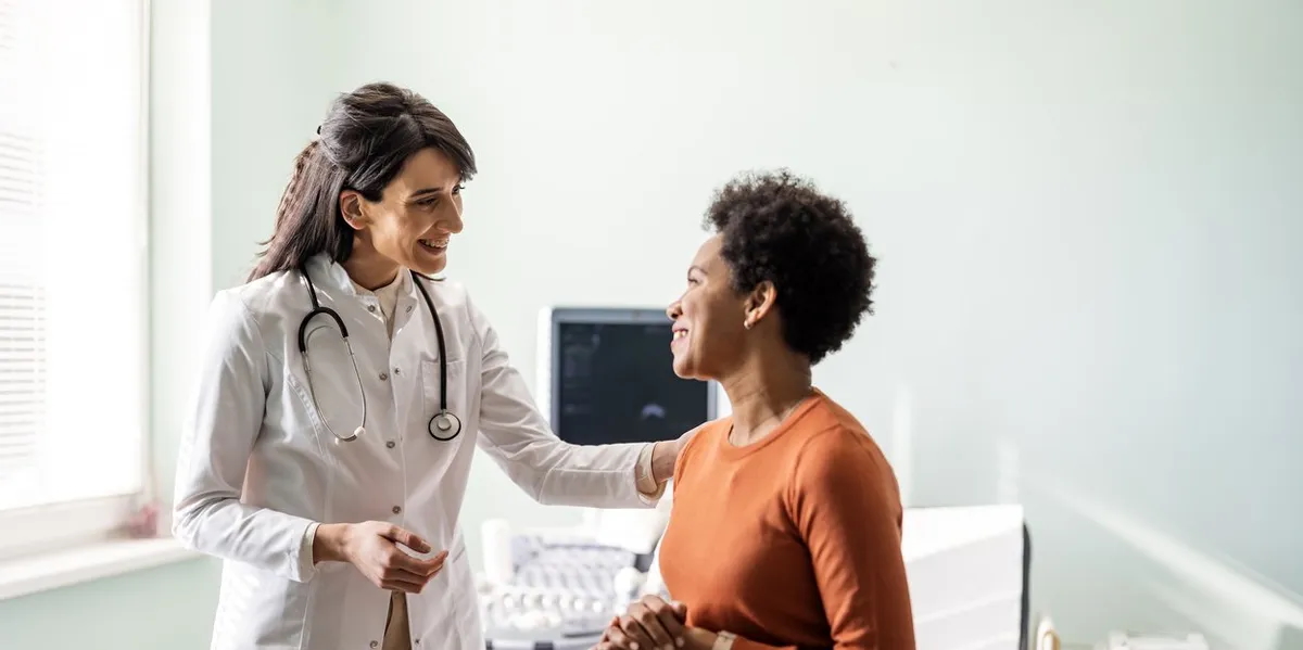 physician talking to patient in office